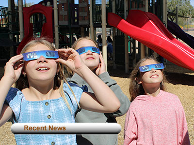 Recent News Students viewing solar eclipse with protective glasses on